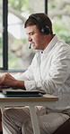 Call center, headset and man in home, laptop and advice for customer service, system solution and talking. Connection, agent and person in lounge, pc and communication for tech support and help desk