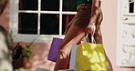 Hands, woman and shopping with bags outdoor for travel, retail purchase and customer experience. Female person, walking or commute with package for bargain, commercial spree and boutique sale in city