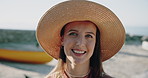 Face, smile and woman at beach for travel, vacation and getaway adventure in nature. Portrait, hat and person outdoor for holiday, tourism and summer trip by coast in California