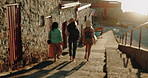 Harbor, steps and walking with woman friends by ocean together for bonding, travel or vacation. Back, holiday and windy with group of people outdoor by sea for adventure, journey or sightseeing