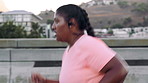 Running, earphones and woman in city, training and endurance for health benefits, audio or routine. Outdoor, person and athlete in street, challenge and exercise for cardio workout, podcast and sound