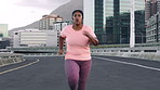 Running, energy and woman in city, fitness and wellness with exercise, cardio workout and practice. Outdoor, person and athlete in street, training for health benefits and breathing with challenge
