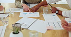 Hands, team or business people with paperwork for discussion, sales revenue or performance data. Meeting, group or planning with document, graphs or investment review for growth strategy in office
