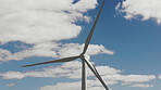 Wind turbine, power and clouds with blue sky for renewable energy or economic development. Windmill, outdoor sustainability or eco friendly environment with natural or alternative resource in nature
