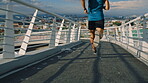 Fitness, back or legs on bridge with running, cardio or stamina exercise in athletic activity. Training, sports hobby or person outdoor with sprint, physical performance or endurance workout in city.