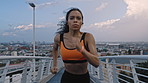 Fitness, running or person on bridge with earphones, cardio playlist or stamina exercise in speed activity. Fast, technology or woman with intense sprint, sports podcast or endurance workout in city.