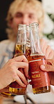 Happy, cheers and friends with beer at lunch for social gathering, reunion and hangout together. Summer, hands and people with alcohol, drinks and toast for bonding, connection and celebration