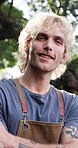 Host, face and man with apron for bbq, happy and getting ready for outdoor event or culinary skills. Backyard, portrait and person with arms crossed on holiday, home and smile with grilling equipment