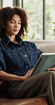 Business, woman and scroll on tablet on sofa for article review, proofreading story or remote work. Freelance editor, african person and tech in home for fact checking, draft editing or news research