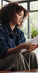 Documents, finance and stress with woman in living room for debt, home budget or tax review. Investment, financial paperwork and reading with person in apartment for anxiety, frustration or loss