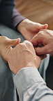 Holding hands, love and couple in home with bonding, empathy or assurance in relationship. Commitment, comfort and man with woman for connection, support and partnership in apartment together.