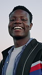 Face, funny and black man in city, fashion and confidence for stylish outfit, calm and weekend break. Outdoor, humor and African person in street, laughing for joke and gen z with trendy clothes