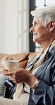 Coffee, thinking and senior woman in home with peace, calm and daydreaming in retirement. Reflection, tea and elderly person in living room with memory, nostalgia and smile for mindset in morning