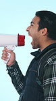 Hiker, shout and man in studio with megaphone for travel announcement, news and information. Profile, scream and person with loud speaker for backpacking tips, broadcast or message on blue background