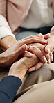 Caregiver, holding hands or old person in home with comfort, understanding or empathy in assisted living. Above, elderly patient or nurse in lounge with help, support or trust in retirement care.
