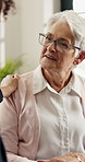 Caregiver, shoulder touch and old woman in home with checkup, advice and empathy in assisted living. Compassion, elderly patient or nurse with help, consultation and support in retirement care.