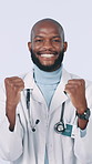 Fist pump, excited and face of doctor in studio for insurance approval, success and good news. Healthcare, celebrate and portrait of black man for promotion, win and achievement on white background