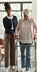 Physiotherapy, help and old woman in clinic with walker, rehabilitation and exercise for mobility. Medical support, healthcare worker and elderly person with disability, physical therapy and healing.