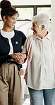 Caregiver, holding hands and walk with elderly woman for support, balance or healthcare service. Assisted living, volunteer or helping senior person with disability, arthritis and recovery in home