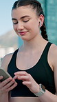 Athlete, smartphone and woman with earphones on break, fitness and song selection on web and online. Happy, runner and person with tech for audio, wellness and streaming music in city and outdoor