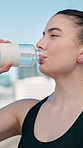 Runner, happy and woman in city with water on break for exercise, workout and fitness outdoor. Sports, town and person with liquid for hydration, minerals and drink for wellness, recovery and health