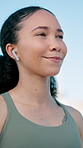 Fitness, thinking and woman with earphones in city for exercise, workout and training with music. Runner, athlete and person with audio, podcast and happy for active hobby, wellness or health in town