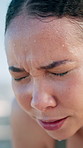 Runner, tired and woman with sweat in city for exercise, cardio workout and intense training. Fitness, athlete and person with fatigue, sweat and breathe for active hobby, wellness and health in town