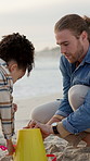 Beach, father and girl with toys, sand castle and bonding together for weekend break, fun and love. Ocean, people or dad with daughter, happiness or bucket for game or building for development at sea