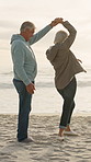 Dancing, beach and senior couple with smile for bonding, travel holiday and tourism for anniversary trip. Romance, sunset and old people with seaside vacation for support, connection and spin partner