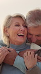 Laughing, outdoor and senior couple with hug for bonding, travel holiday and joke for anniversary trip. Love, winter vacation and old people with humor for connection, smile and support for tourism