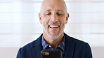 Business, funny and phone with happy man on in office for corporate development or management. App, laughing and scrolling with excited manager on wall background at work for mobile communication