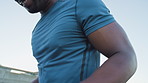 Man, warm up and jog on spot in city with smile, fitness and muscle wellness on urban bridge. African person, runner and happy for cardio exercise, circulation or low angle with summer in town