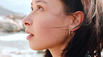 Woman, relax and reflection on beach with wind, peace and tranquil getaway for inspiration on vacation. Person, mindfulness and thinking outdoor by ocean with breeze, wellness and memory on holiday.