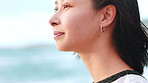 Woman, thinking and peace on beach with wind, relax and tranquil getaway for inspiration on vacation. Space, female person and reflection outdoor by ocean with breeze, wellness and memory on holiday.