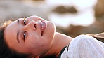 Face, woman and lying on beach with smile for travel, meditation and peace on holiday getaway. Portrait, person and breathing for fresh air, stress relief and calm morning on tropical vacation at sea