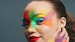 Happy woman, face paint and art in studio with beauty, color and cosmetics with smile on background. Girl, lipstick and makeup for skin, confident or portrait with splash for aesthetic in Costa Rica