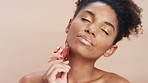 Beauty, flower and wellness with woman on studio background for cosmetics or dermatology. Natural, organic or vegan skincare and model person with orchid plant for satisfaction or sustainability