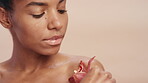 Beauty, plant and wellness with woman on studio background for cosmetics or dermatology. Green, organic or vegan skincare and model person with orchid flower for satisfaction or sustainability