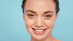 Face, skincare and woman in studio for natural beauty, glow and wellness on blue background. Smile, dermatology and portrait of person with shine, skin health and texture with cosmetics for aesthetic