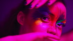 Neon light, beauty and woman with makeup, face paint and aesthetic with transformation on background. Portrait, cosmetics and serious person with art in studio, color and creative with glamour