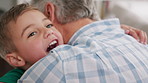 Grandfather, child and hug for love in home, trust and connection together with family reunion. Kid, excited boy and embrace grandparent for safety, security and support with generations for care