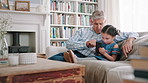 Cellphone, relax and grandfather with kid on sofa in home for social media, networking or texting together. Bonding, tech and senior man with girl child on phone for message on mobile app in house.