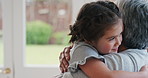 Grandma, child and hug for love in home, trust and connection together with foster family. Kid, girl and embrace with happy grandmother, bonding and support for adoption with interracial people
