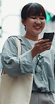 Winning, walking and Asian woman with phone in city for location, commute and travel on weekend. Outdoor, online bonus and person on smartphone for connection, social media and good news in Japan