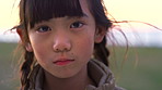 Face, nature and girl in park, kid and summer holiday to relax, travel weekend and breeze. Outdoor, youth and Asian child with break, sunshine or wellness with vacation, adventure or getaway trip