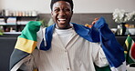 Victory, face and football fan in house with flag, goal excitement or celebration in sports tournament. POV, watching soccer or black man with game, score lead or winning cheer in South Africa.