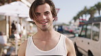 Travel, face or man in town with smile, positive attitude or summer break in urban vacation. Portrait, tourist holiday or male person with happiness, good mood or city sightseeing in Los Angeles.