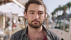 Serious, holiday and face of man in city for travel, getaway or weekend trip in summer with relax. Break, confident and portrait of male person on vacation with positive attitude in urban town.
