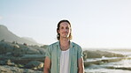 Outdoor, face and man at beach, travel and adventure on summer vacation in nature and smile on space. Ocean, traveler and happy person on holiday, break and confident on weekend in San Francisco