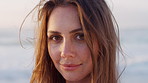 Breeze, sunrise and face of woman on beach for summer holiday, vacation and trip on weekend. Travel, happy and portrait of person by ocean for fresh air, calm and relax on break, tourism and nature